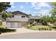 Well-maintained home with a gray exterior, a two-car garage, and a landscaped front yard at 9383 W Colorado Ave, Lakewood, CO 80232