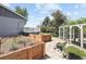 Backyard garden features raised garden beds, a chicken coop, and a stone pathway, perfect for gardening enthusiasts at 9383 W Colorado Ave, Lakewood, CO 80232