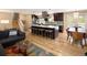 Modern kitchen open to a living area featuring a large island with seating and hardwood floors at 9383 W Colorado Ave, Lakewood, CO 80232