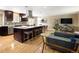 Open-concept kitchen featuring stainless steel appliances, a large island, and wood floors at 9383 W Colorado Ave, Lakewood, CO 80232