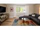 Comfortable living room with a large window, a stylish rug, and a modern entertainment center at 9383 W Colorado Ave, Lakewood, CO 80232