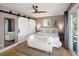 Inviting main bedroom featuring sliding closet doors, ceiling fan, natural light, and access to a private balcony at 9383 W Colorado Ave, Lakewood, CO 80232