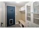 Mudroom with a blue door, bench with baskets, and built-in storage for a functional entryway at 9383 W Colorado Ave, Lakewood, CO 80232