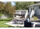 Outdoor patio featuring dining furniture, a grill, lounge chairs, and a staircase to a deck at 9383 W Colorado Ave, Lakewood, CO 80232