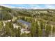 Stunning aerial view of the condo complex nestled in the trees, with mountain views at 877 Airport Rd # 19, Breckenridge, CO 80424