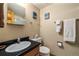Bathroom featuring a vanity with black countertop, wall-mounted towel racks, and mountain artwork at 877 Airport Rd # 19, Breckenridge, CO 80424