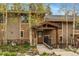 Inviting exterior showcasing the home's entrance, with stone accents and mature trees at 877 Airport Rd # 19, Breckenridge, CO 80424