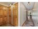Hallway featuring wood-paneled doors and overhead lighting, seamlessly connecting different areas of the home at 877 Airport Rd # 19, Breckenridge, CO 80424