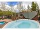 Inviting outdoor hot tub with stone accents, offering a serene retreat for relaxation and enjoyment at 877 Airport Rd # 19, Breckenridge, CO 80424