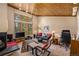 Comfortable living room featuring large windows, a cozy fireplace, and a workspace at 877 Airport Rd # 19, Breckenridge, CO 80424
