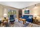 A comfortable living room with a fireplace and sliding door to the deck with scenic views at 877 Airport Rd # 19, Breckenridge, CO 80424
