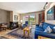 Comfortable living room with fireplace and sliding glass door to outdoor scenery at 877 Airport Rd # 19, Breckenridge, CO 80424
