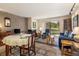 Cozy living room with fireplace, dining area, and sliding glass doors to the outside at 877 Airport Rd # 19, Breckenridge, CO 80424