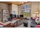 Living room with fireplace, large windows showcasing mountain views and built-in shelving at 877 Airport Rd # 19, Breckenridge, CO 80424
