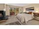 Charming bedroom with a stone fireplace and a bright view of the natural surroundings at 877 Airport Rd # 19, Breckenridge, CO 80424