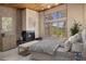 Comfortable main bedroom with fireplace and large windows showcasing mountain views at 877 Airport Rd # 19, Breckenridge, CO 80424
