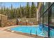 Outdoor pool surrounded by greenery, offering a refreshing retreat with a relaxing and scenic environment at 877 Airport Rd # 19, Breckenridge, CO 80424