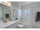 Bathroom with white subway tile, white decorative shower curtain, and a new sink and toilet at 230 W 78Th Pl, Denver, CO 80221