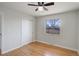 Empty bedroom featuring hardwood floors, a sliding door closet, a window and neutral walls at 230 W 78Th Pl, Denver, CO 80221