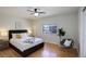 Bright bedroom featuring hardwood floors, ceiling fan, stylish chair, and a large window at 230 W 78Th Pl, Denver, CO 80221