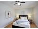 Bedroom showcasing neutral walls, a comfortable bed with fluffy pillows, and wood nightstands at 230 W 78Th Pl, Denver, CO 80221