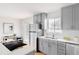 Modern kitchen with stainless steel appliances, gray cabinets, and white countertops at 230 W 78Th Pl, Denver, CO 80221