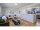 Open concept living space flowing into the kitchen, featuring modern decor and hardwood flooring at 230 W 78Th Pl, Denver, CO 80221
