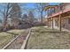 The backyard features a well-maintained lawn, privacy fence, and partial views of the house with an elevated deck at 6534 Field St, Arvada, CO 80004