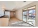 Finished basement with kitchenette, carpet and large sliding glass doors to patio at 6534 Field St, Arvada, CO 80004