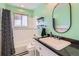 Bathroom features tiled shower/tub combination, granite counters and open shelving at 6534 Field St, Arvada, CO 80004