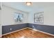 Neutral bedroom with two windows and hardwood floors offers lots of natural light at 6534 Field St, Arvada, CO 80004