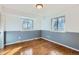 Bright bedroom with two windows and hardwood floors, painted in neutral tones at 6534 Field St, Arvada, CO 80004