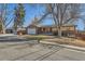 Inviting ranch-style home with a brick and siding facade, attached garage, and a well-manicured lawn in a quiet neighborhood at 6534 Field St, Arvada, CO 80004