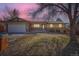 Charming single-Gathering house with a well-manicured lawn and landscape, garage, and inviting curb appeal at dusk at 6534 Field St, Arvada, CO 80004