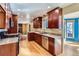 Beautiful kitchen with stainless steel appliances, granite countertops, and cherry wood cabinets with hardwood floors at 6534 Field St, Arvada, CO 80004