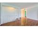 Open-concept living area with hardwood floors and neutral walls leading to an airy and bright staircase at 6534 Field St, Arvada, CO 80004