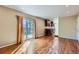 Open living room boasts hardwood floors, access to a deck, and views to kitchen at 6534 Field St, Arvada, CO 80004