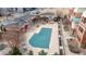 Aerial view of community pool and buildings with landscaping, patio areas and convenient parking spaces at 4100 Albion St # 205, Denver, CO 80216