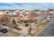 Aerial view of a community center featuring a unique roof design and landscaped grounds in a neighborhood setting at 4100 Albion St # 205, Denver, CO 80216