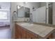 Bathroom vanity with tile countertop and stainless steel faucet, and modern lighting at 4100 Albion St # 205, Denver, CO 80216