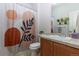 Bathroom with tile floors, a vanity, toilet, and decorative shower curtain at 4100 Albion St # 205, Denver, CO 80216