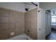 Bathroom with tiled shower, bathtub, and a view to the bedroom at 4100 Albion St # 205, Denver, CO 80216