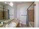 Functional bathroom with a tiled shower, bathtub, and a well-lit mirror at 4100 Albion St # 205, Denver, CO 80216
