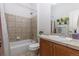A clean bathroom featuring a tub and shower combination and a tile vanity at 4100 Albion St # 205, Denver, CO 80216