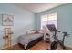 Bedroom with a bed, desk, exercise equipment, and natural light at 4100 Albion St # 205, Denver, CO 80216
