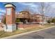 Attractive brick building with well-manicured landscaping, signage, and inviting entrance at 4100 Albion St # 205, Denver, CO 80216