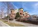 Charming condo building showing the building's brick exterior and landscaped common areas at 4100 Albion St # 205, Denver, CO 80216