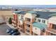 Charming condos with colorful brick, multiple balconies, and mountain views in the distance at 4100 Albion St # 205, Denver, CO 80216