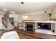 Open-concept living room with modern finishes, fireplace, and staircase at 4100 Albion St # 205, Denver, CO 80216