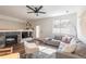 Bright living room with a cozy fireplace, stylish seating, and large windows at 4100 Albion St # 205, Denver, CO 80216
